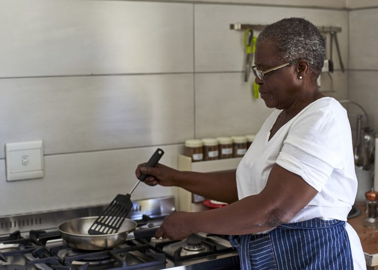 senior-woman-cooking-at-gas-stove-in-kitchen