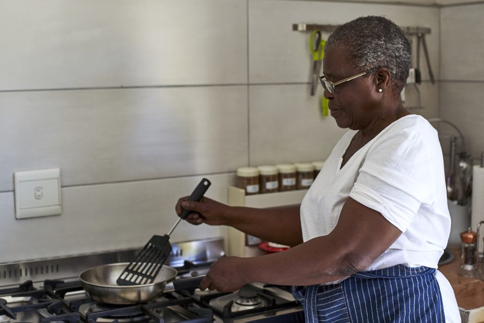 senior-woman-cooking-at-gas-stove-in-kitchen