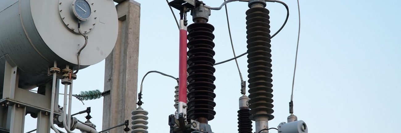 Power transformer. Electrical equipment. Electric substation. High voltage transformer against the blue sky. Electric current redistribution substation Power transformer. Electrical equipment. Electric substation. High voltage transformer against the blue sky. Electric current redistribution substation