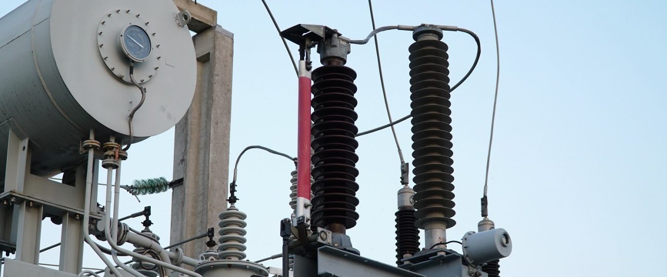 Power transformer. Electrical equipment. Electric substation. High voltage transformer against the blue sky. Electric current redistribution substation