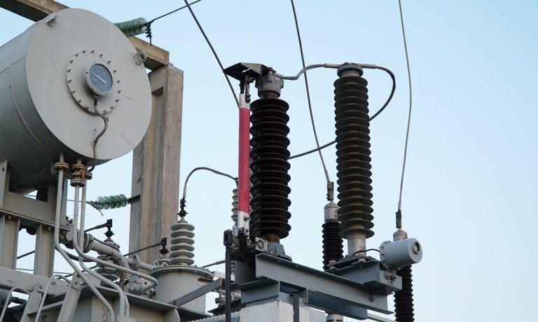 Power transformer. Electrical equipment. Electric substation. High voltage transformer against the blue sky. Electric current redistribution substation Power transformer. Electrical equipment. Electric substation. High voltage transformer against the blue sky. Electric current redistribution substation