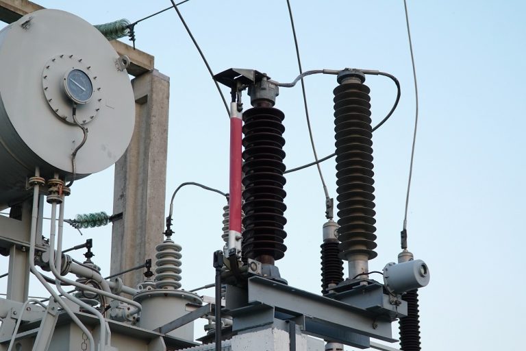 Power transformer. Electrical equipment. Electric substation. High voltage transformer against the blue sky. Electric current redistribution substation