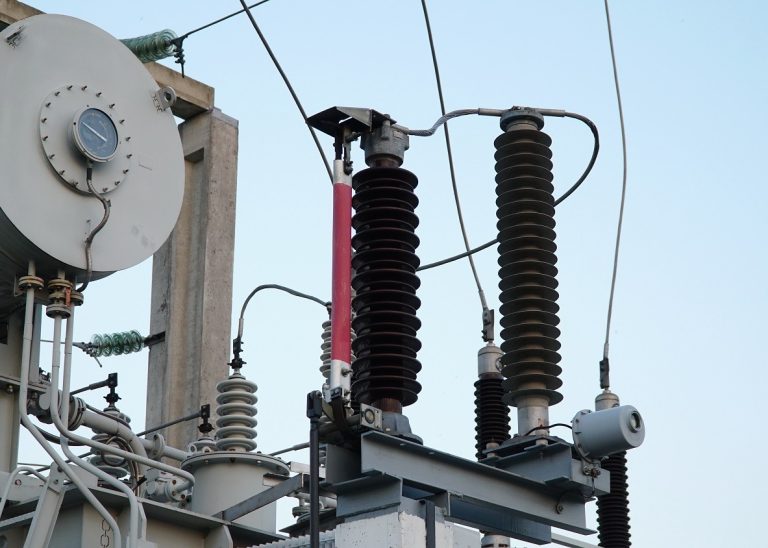 Power transformer. Electrical equipment. Electric substation. High voltage transformer against the blue sky. Electric current redistribution substation