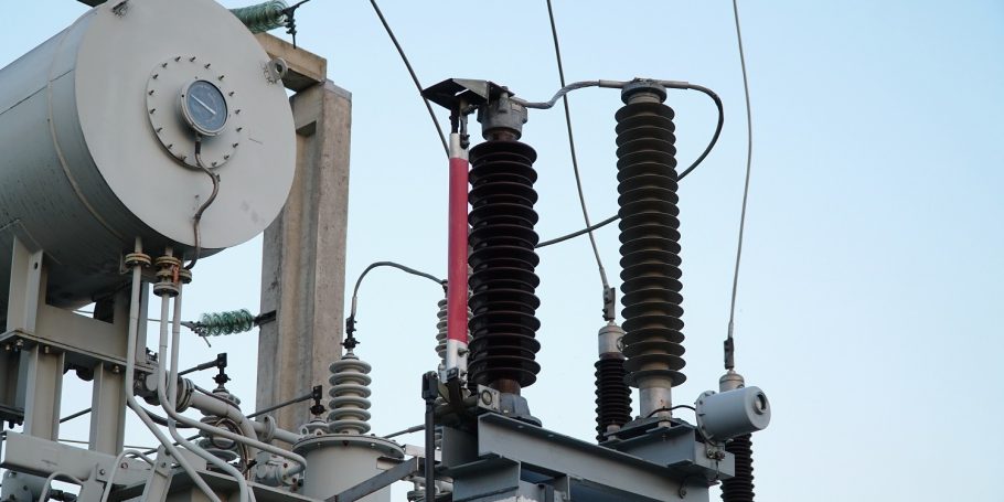 Power transformer. Electrical equipment. Electric substation. High voltage transformer against the blue sky. Electric current redistribution substation