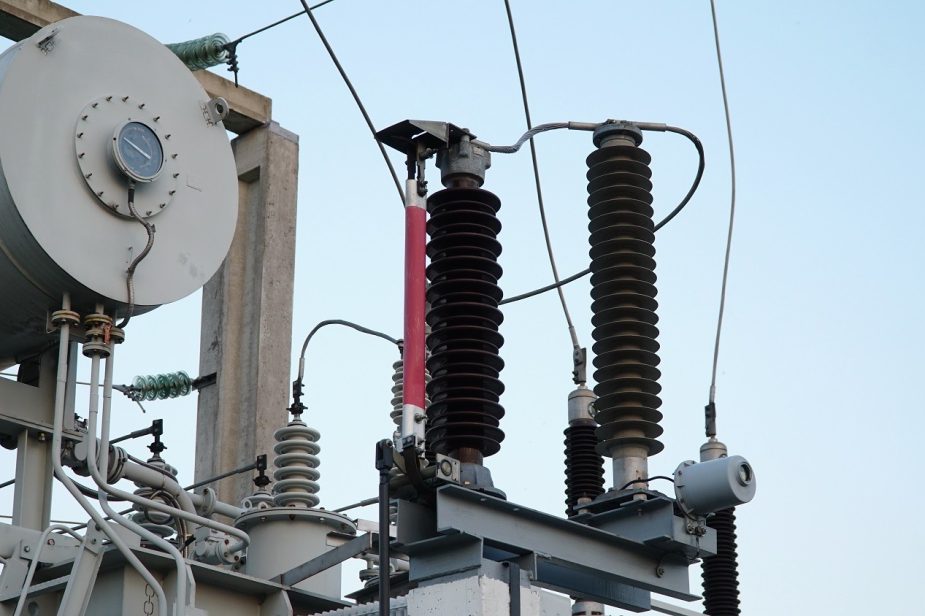 Power transformer. Electrical equipment. Electric substation. High voltage transformer against the blue sky. Electric current redistribution substation Power transformer. Electrical equipment. Electric substation. High voltage transformer against the blue sky. Electric current redistribution substation