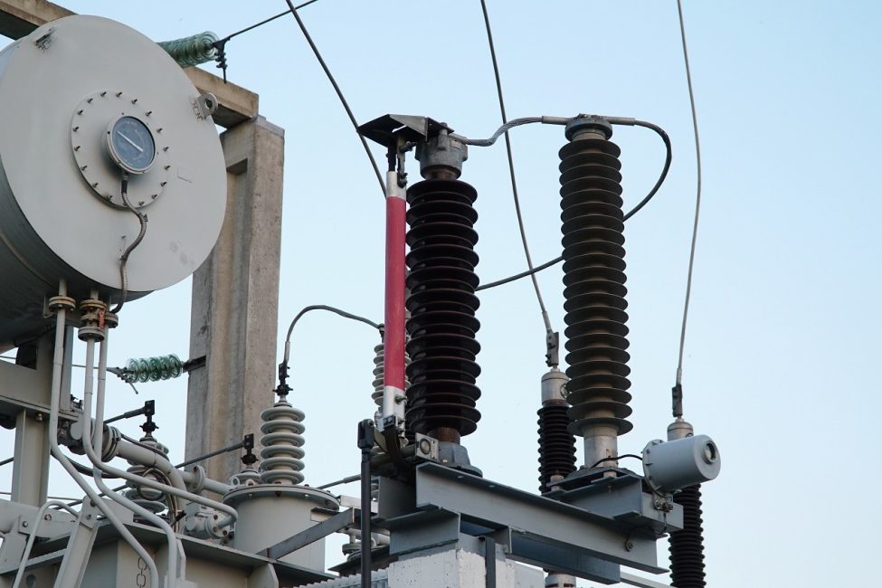 Power transformer. Electrical equipment. Electric substation. High voltage transformer against the blue sky. Electric current redistribution substation