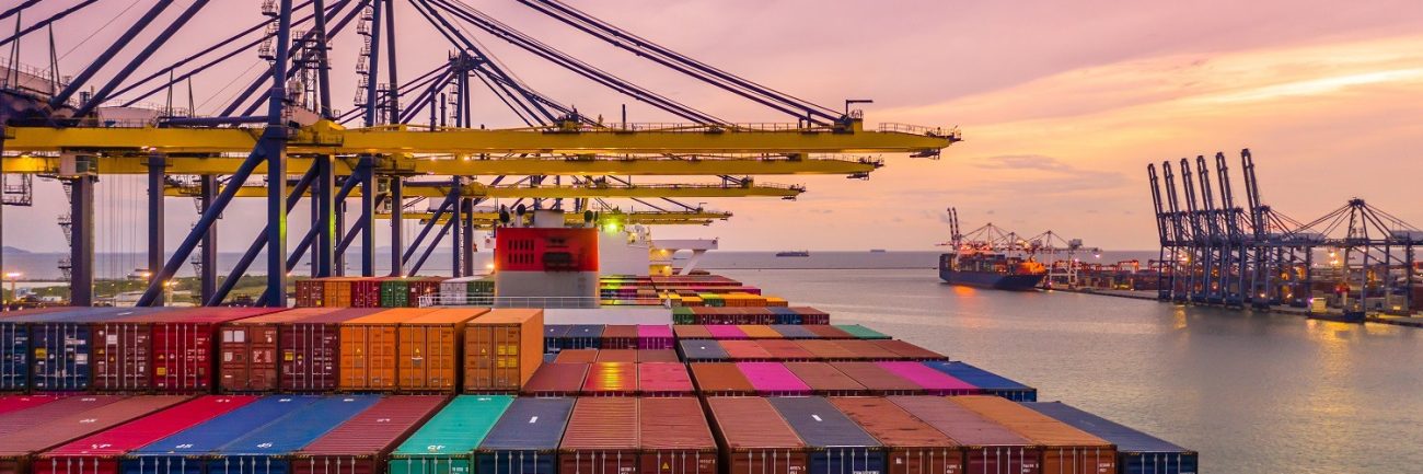 Container ship loading and unloading in deep sea port at sunset, Container ship loading and unloading in deep sea port at sunset,