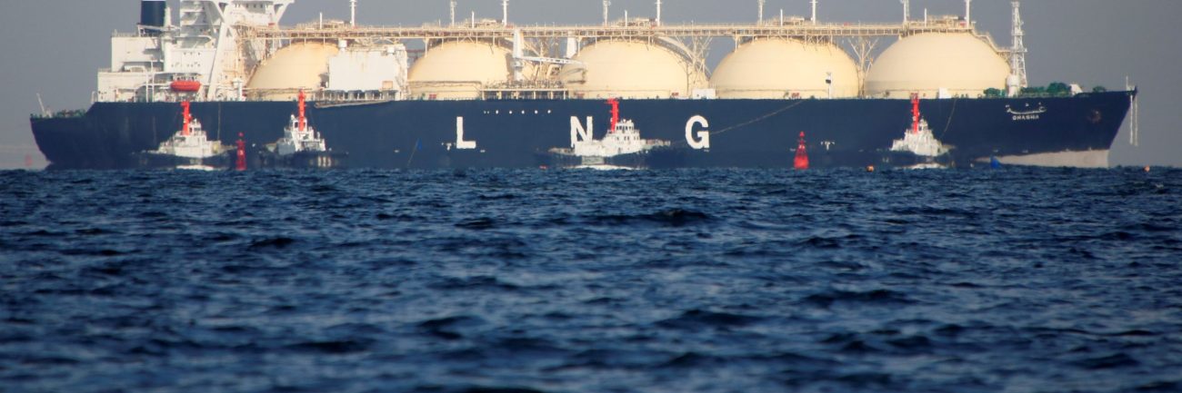 A LNG tanker is tugged towards a thermal power station in Futtsu