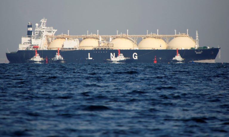 A LNG tanker is tugged towards a thermal power station in Futtsu