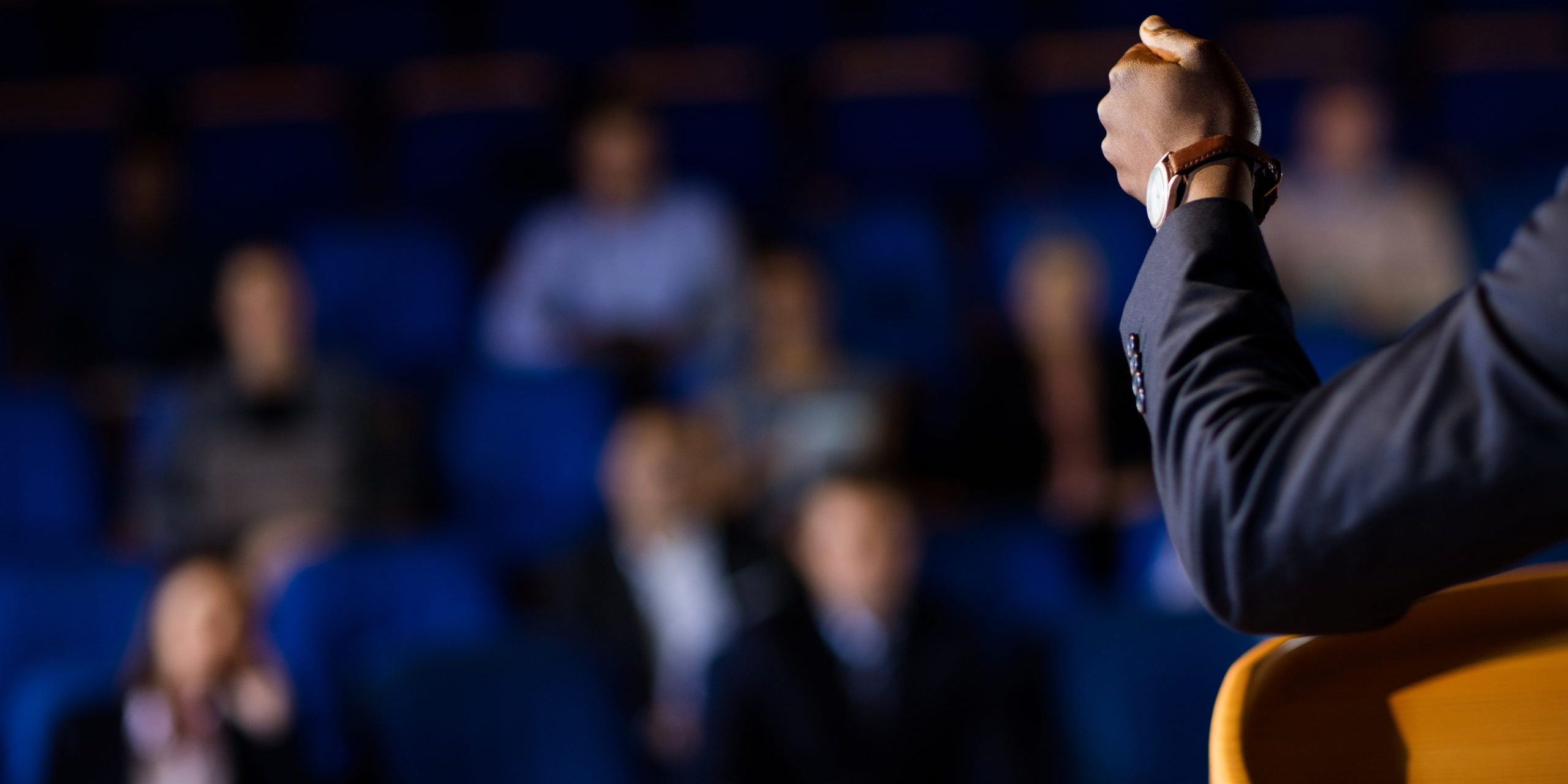 Male business executive giving a speech at conference center