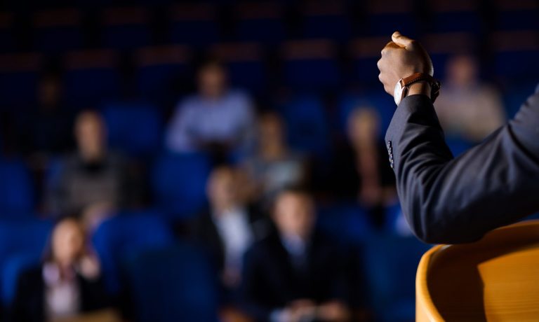 Male business executive giving a speech at conference center