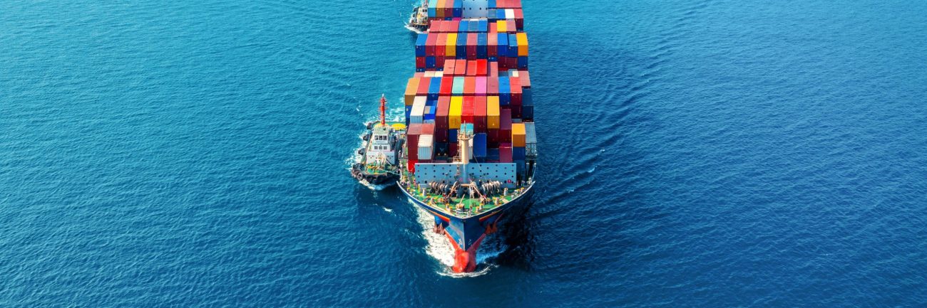 Aerial view of cargo ship with cargo container on sea.
