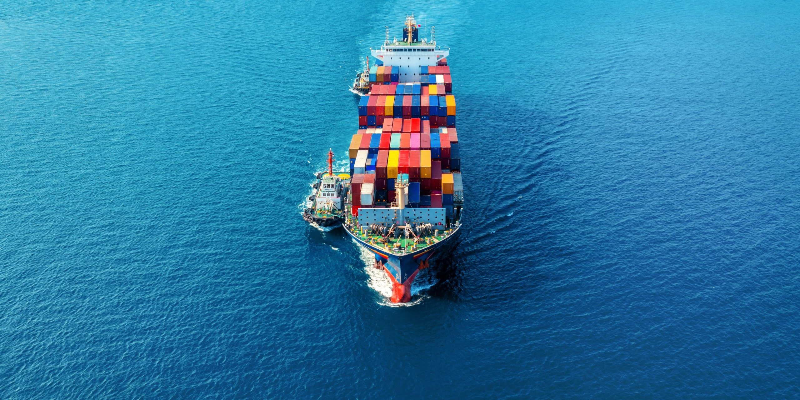 Aerial view of cargo ship with cargo container on sea.
