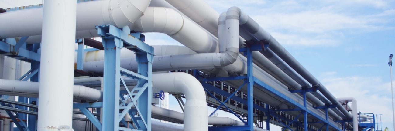 Closeup of industrial pipelines around a factor on a sunny day