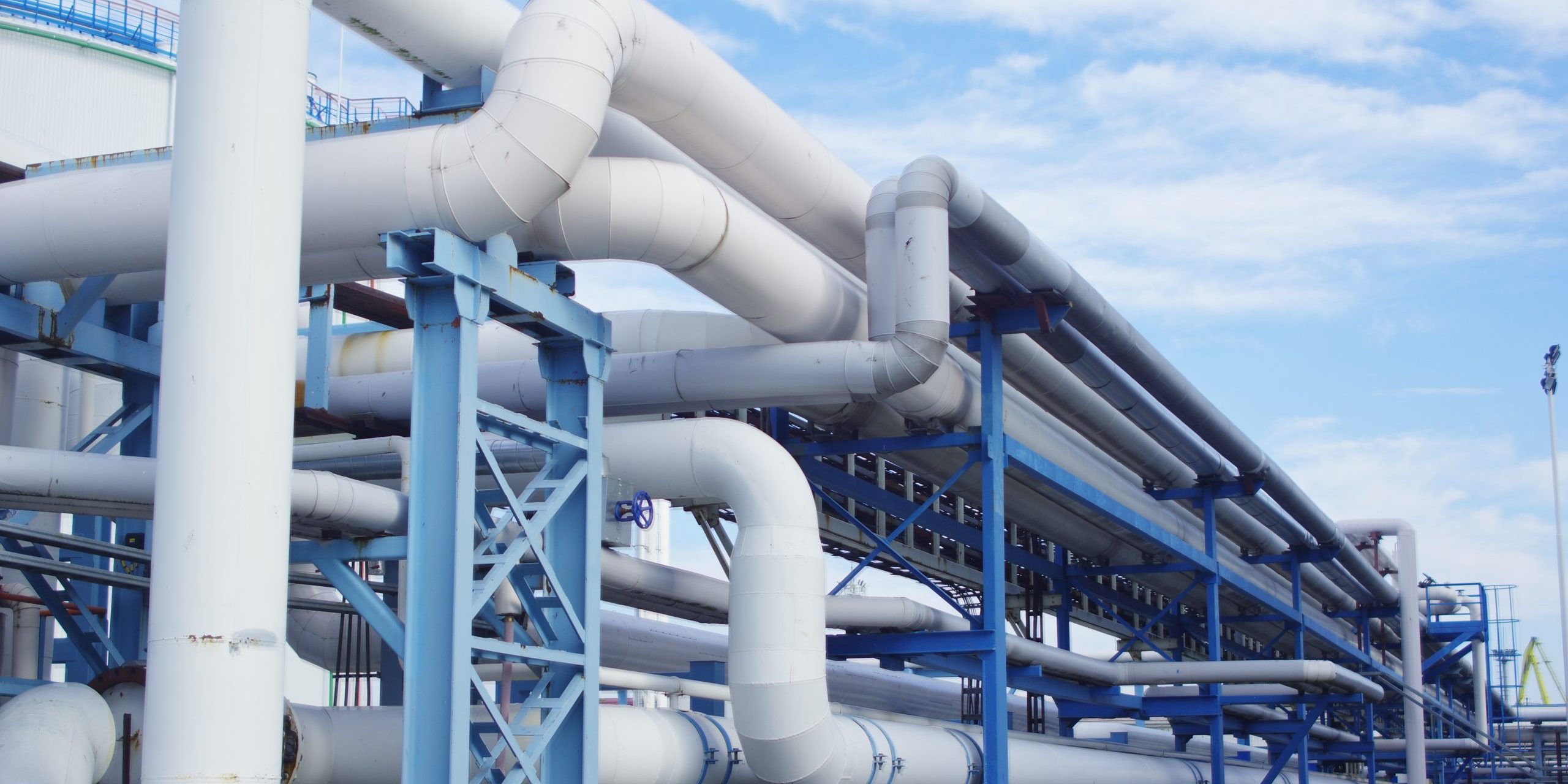 Closeup of industrial pipelines around a factor on a sunny day