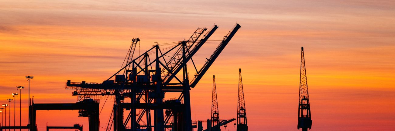Beautiful silhouette of port machinery during sunset