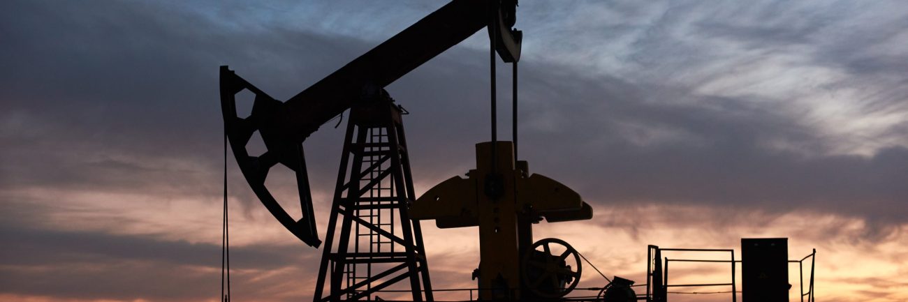 Beautiful sunset over oil field with pump jack.