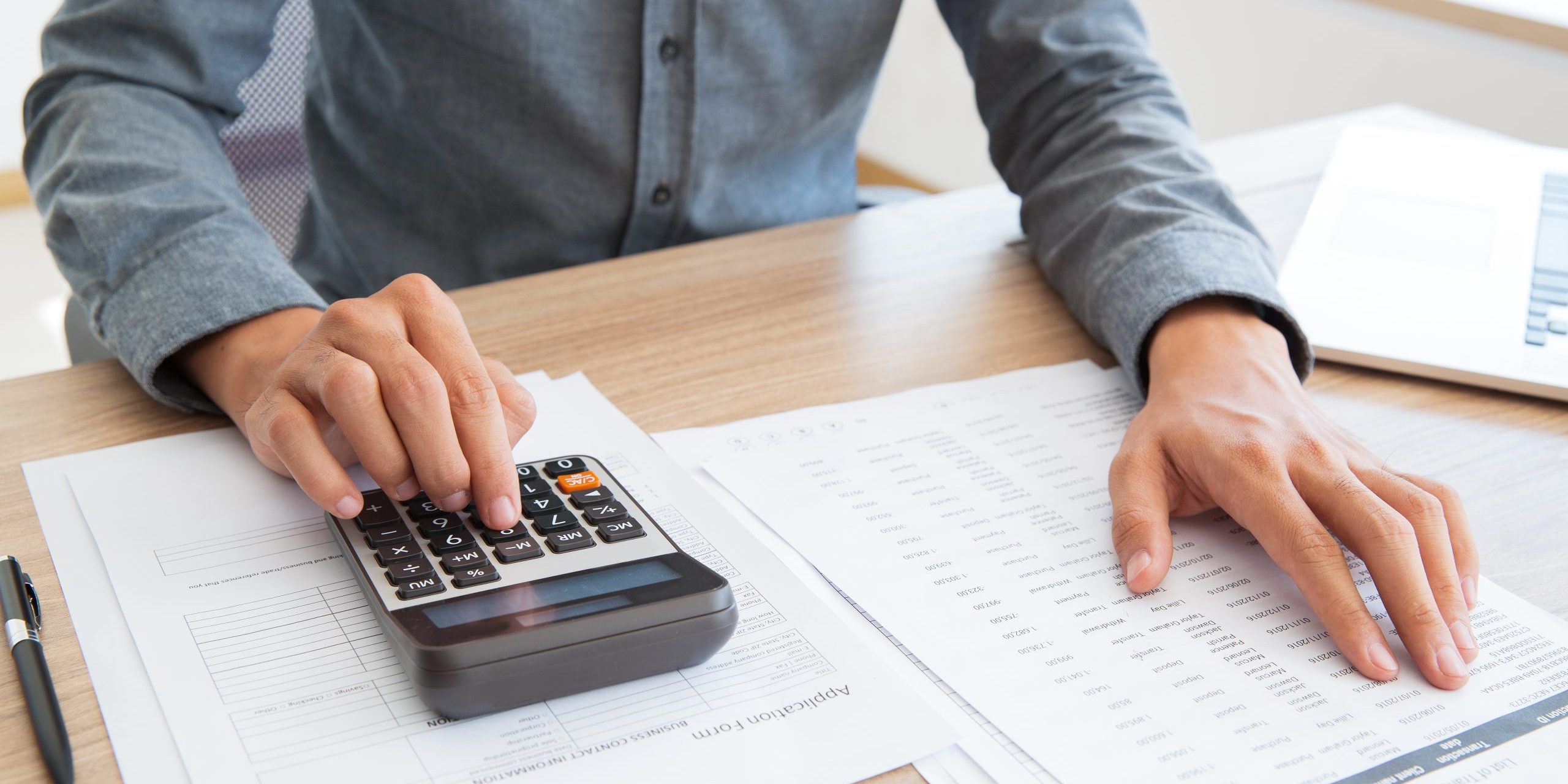 Accountant calculating income and examining report