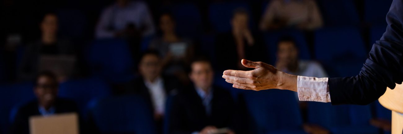 Male business executive giving a speech at conference center