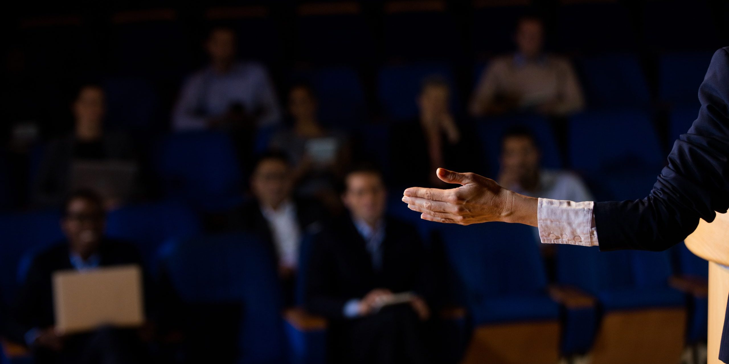 Male business executive giving a speech at conference center