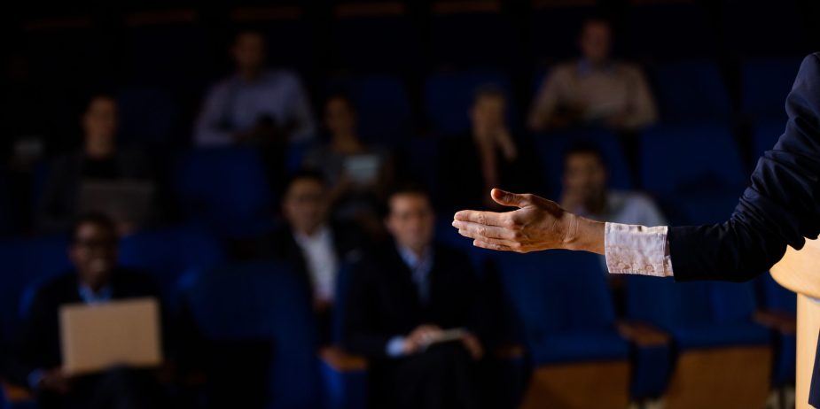 Male business executive giving a speech at conference center