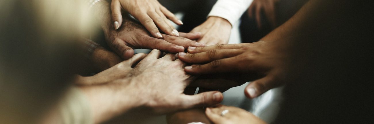 Closeup of diverse people joining their hands