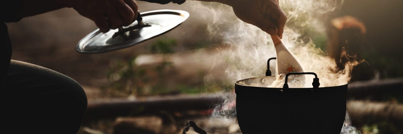 Beautiful silhouette the cook rice with flare lighting and steam