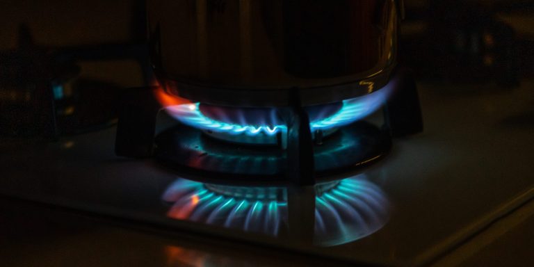 Blue flames of gas burning from a kitchen gas stove