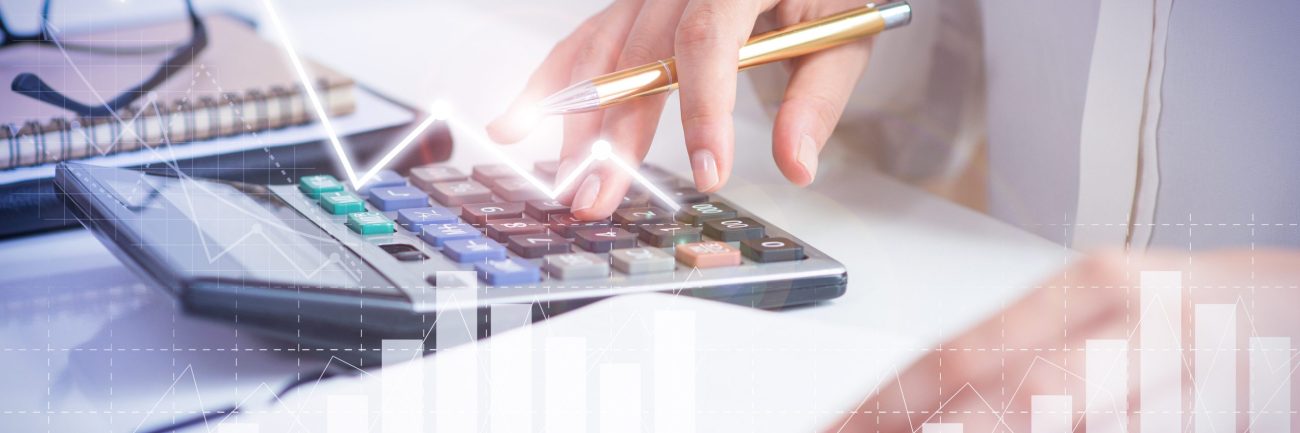 Accountant calculating profit with financial analysis graphs