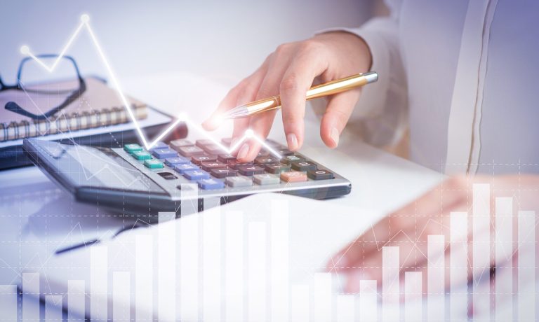 Accountant calculating profit with financial analysis graphs