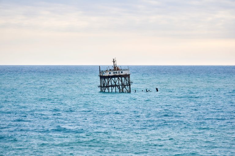 seascape with a rickety structure on the stilts of an aquaculture farm