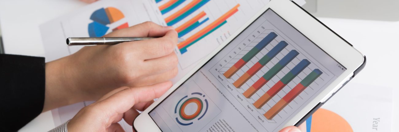 Close-up of business team using digital tablet with financial d