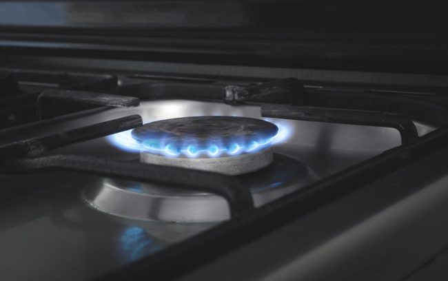 Gas burner with a burning fire. Kitchen gas