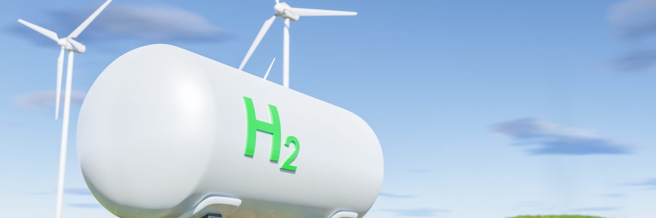 Tanks with gas near wind turbines in green field