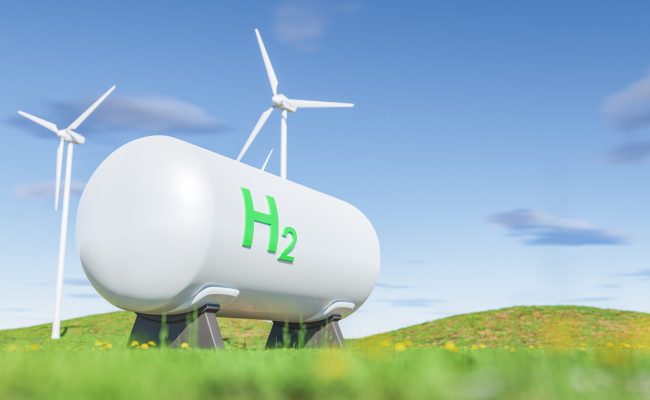 Tanks with gas near wind turbines in green field