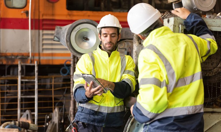 Worker at machine in factory, Metal industry worker at factory.