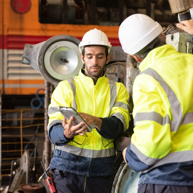 Worker at machine in factory, Metal industry worker at factory.