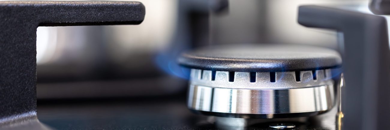 Gas burner macro. Flame detail. Modern kitchen surface.