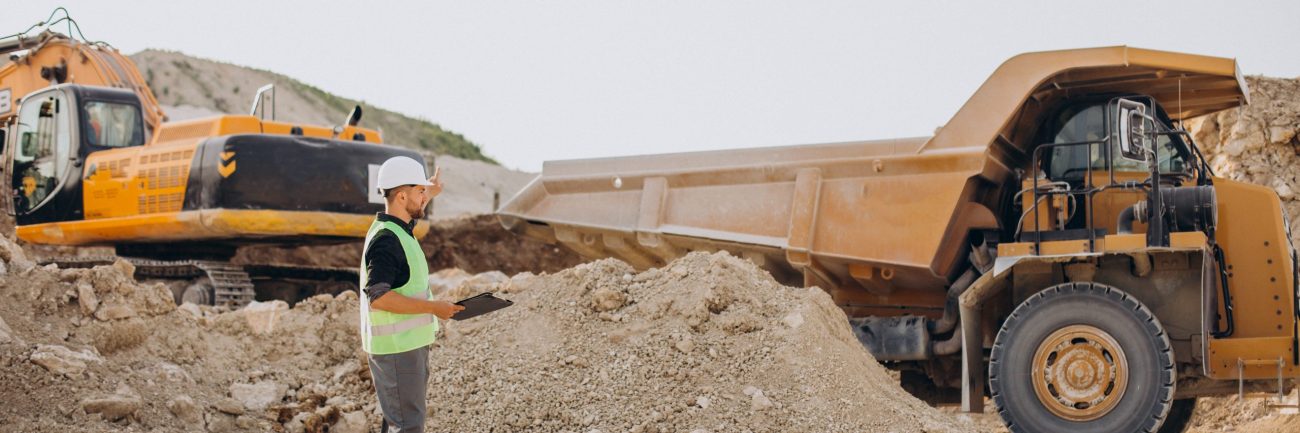 Male worker with bulldozer in sand quarry