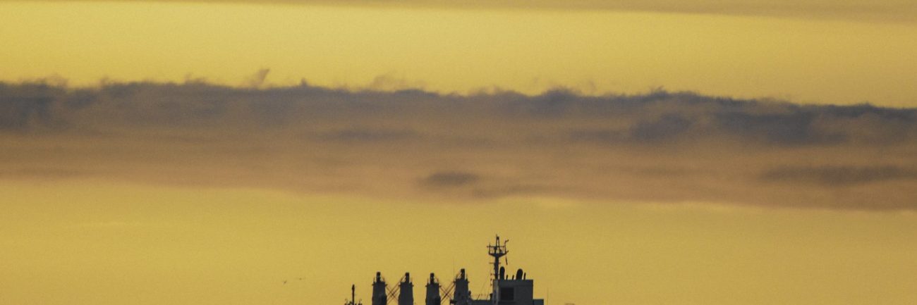 vertical-shot-old-ship-lake-colorful-sky-sunset
