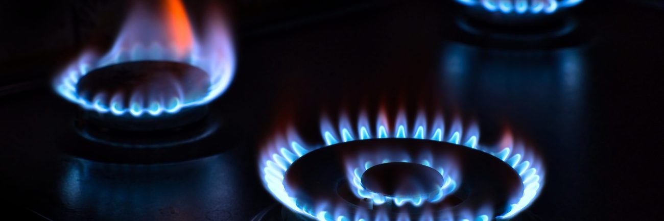 Natural gas burning on the stove. Blue flame. Three burners.