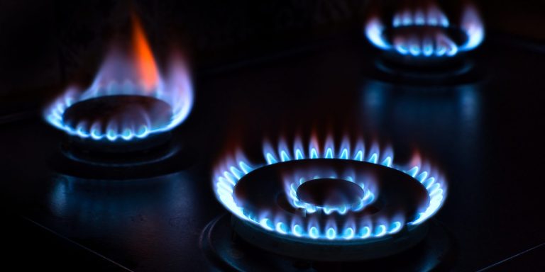Natural gas burning on the stove. Blue flame. Three burners.